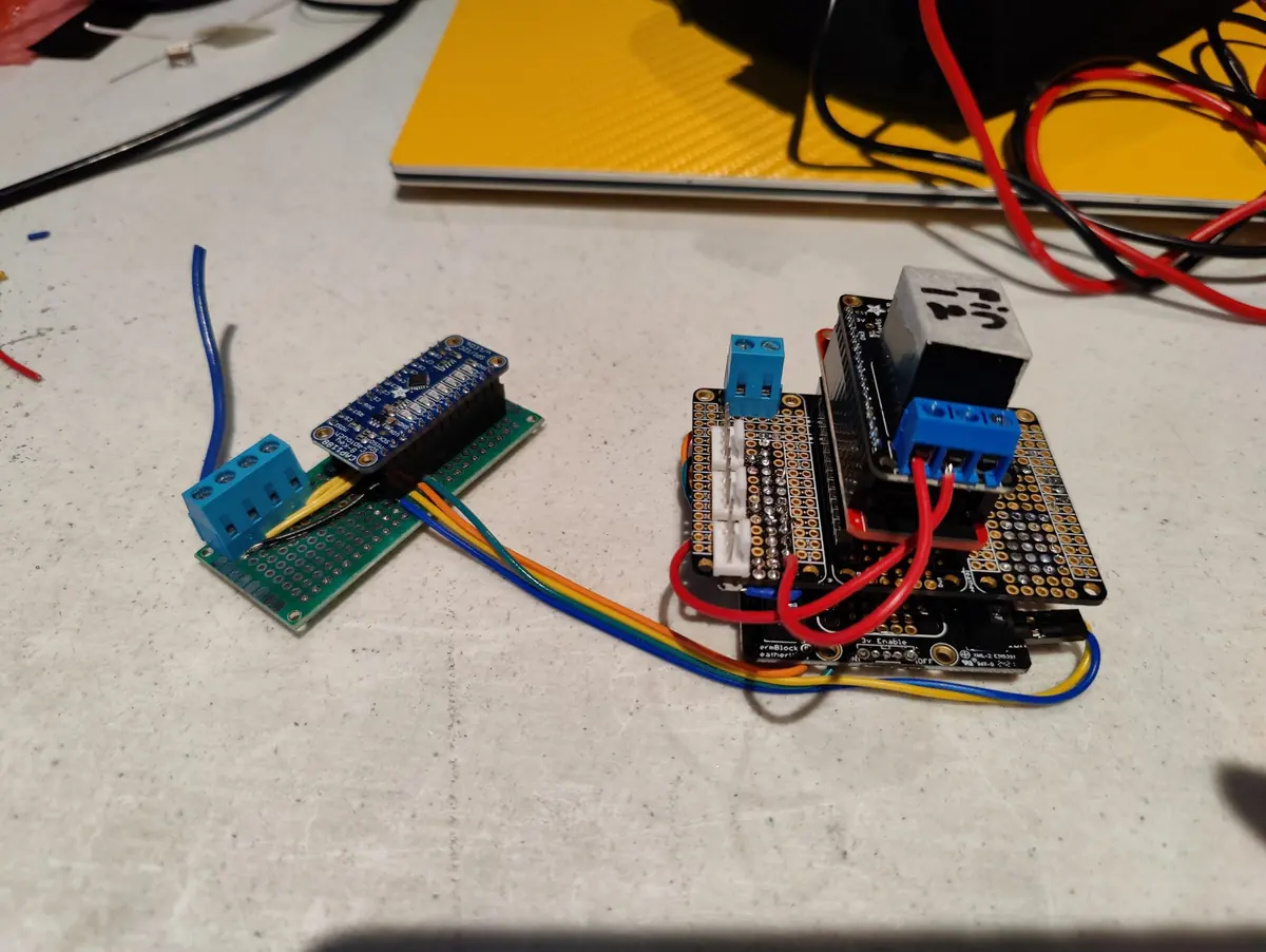 Two small development boards wired to relay modules on a workbench