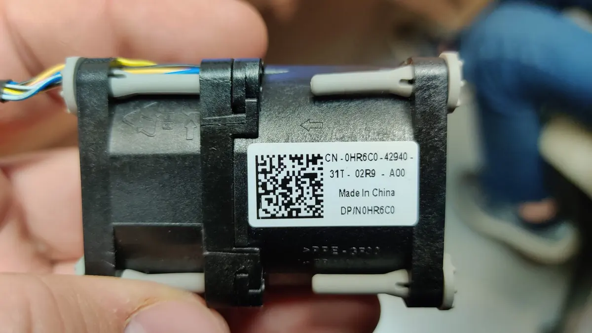 A compact Dell server fan held in hand