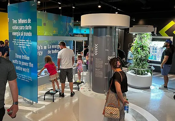 Clear vertical tubes forming a bar graph on the Energy exhibition floor