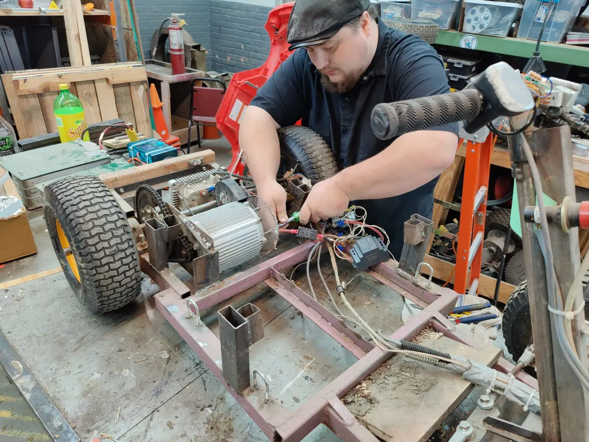 James wiring the electronics on an electric go-kart frame