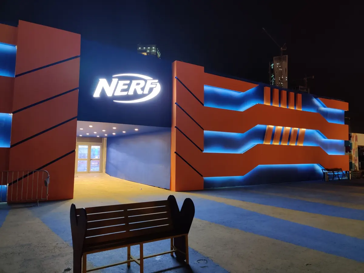 The NERF Challenge entrance, lit orange and blue at night