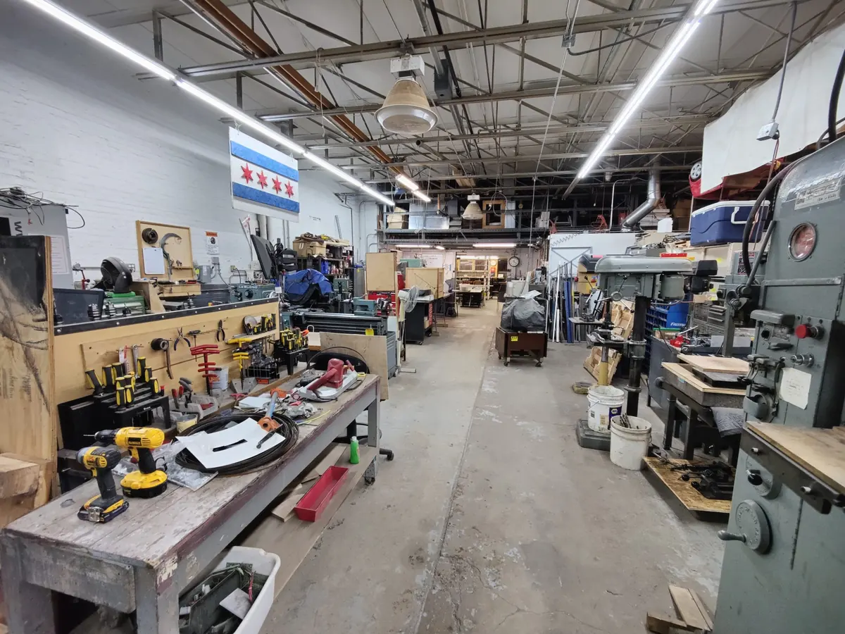 The cold metals shop, with workbenches and machine tools down a long aisle